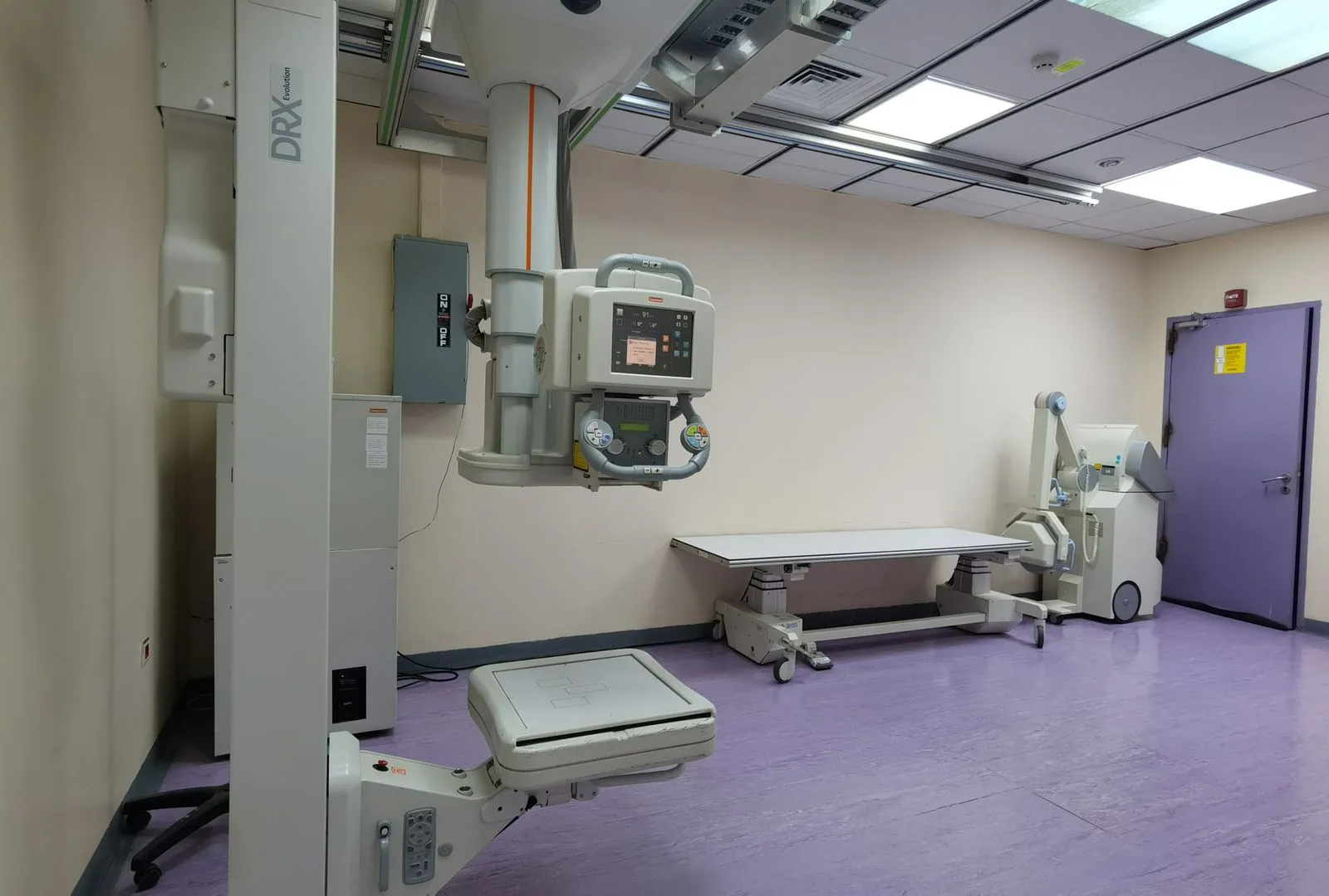 Precision MedLab biomedical technician calibrating patient monitoring equipment at a surgical center